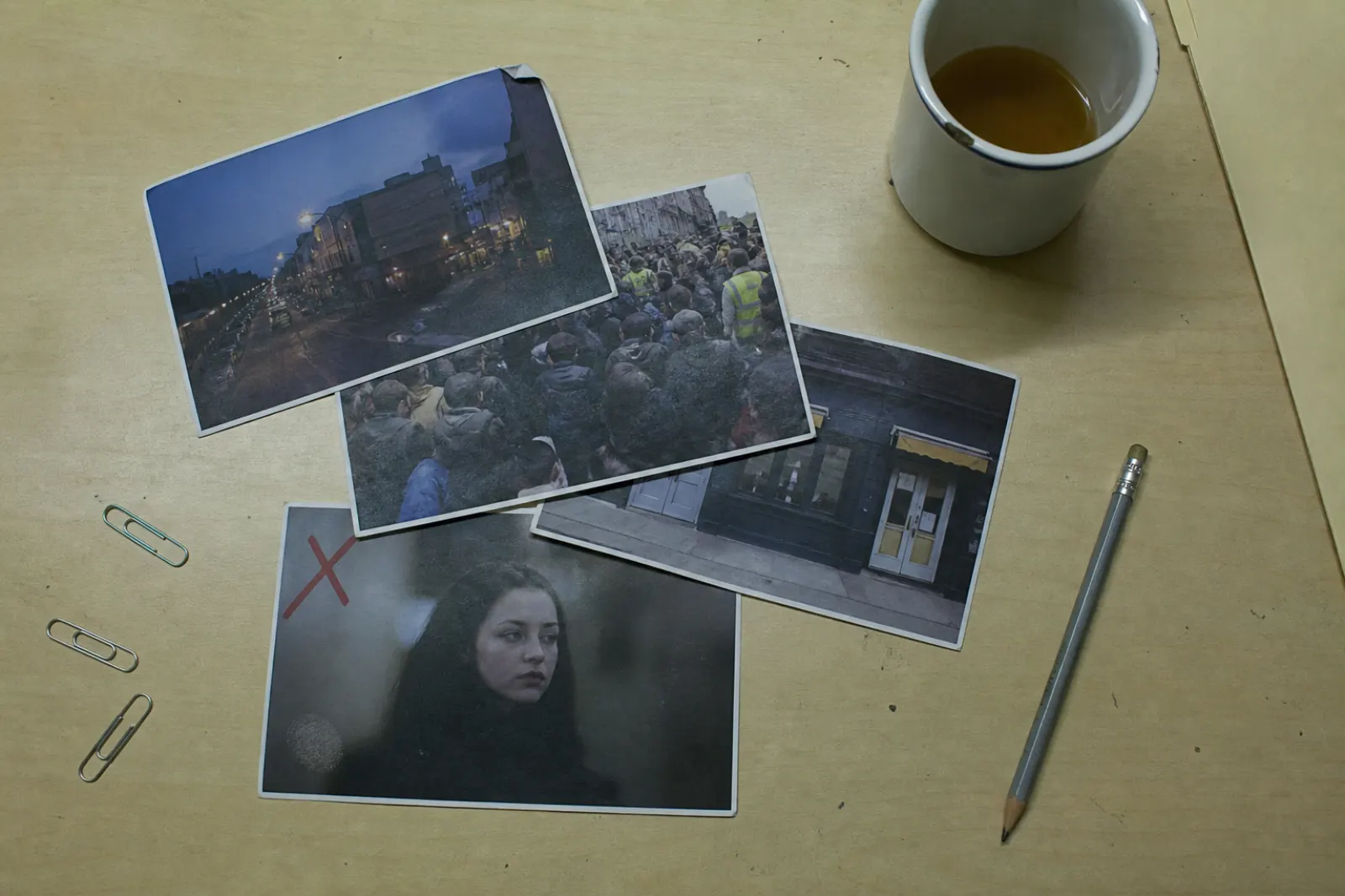 Printed photos on a desk. One is marked. The question is which ones were taken.